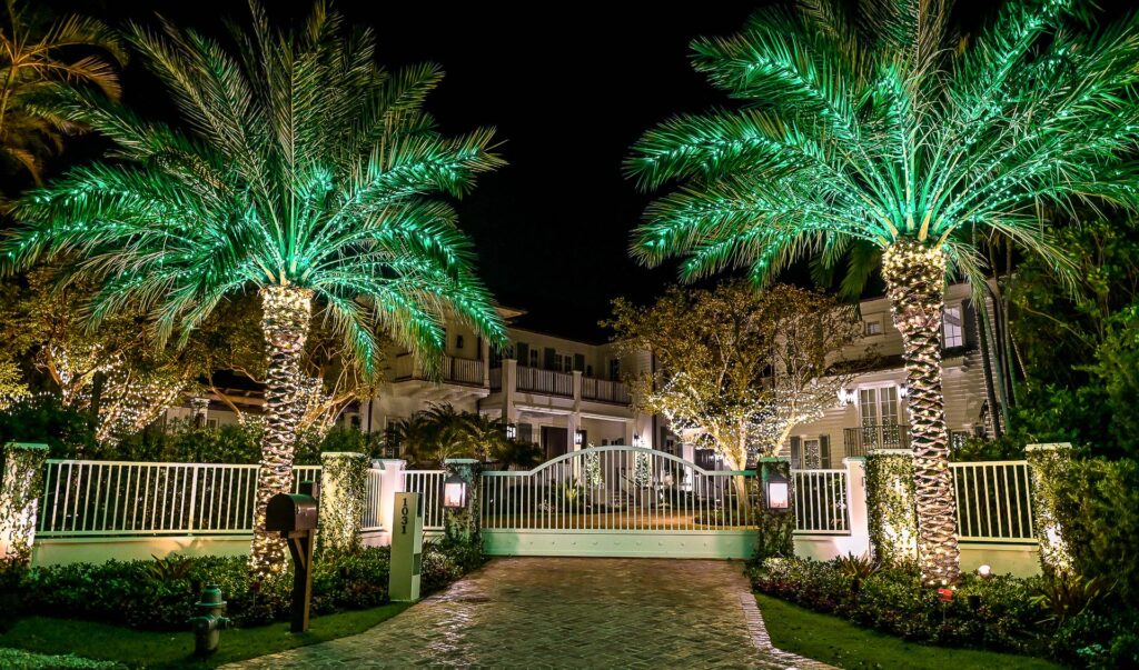 Breathtaking holiday-style lighting installation in various palm trees and regular trees on a big and wealthy property